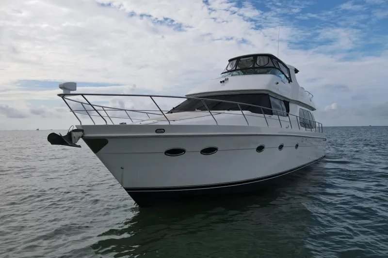 Slide: The Image of 2004 Carver 560 Voyager yacht on calm sea under a partly cloudy sky. - 10