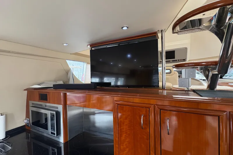 Slide: The Image of Luxurious interior of 2004 Carver 560 Voyager yacht with TV and modern kitchen amenities. - 18