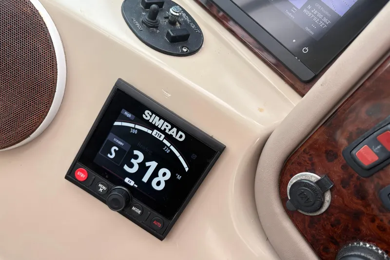 Slide: The Image of Simrad navigation system on 2004 Carver 560 Voyager yacht dashboard, displaying heading 318. - 24