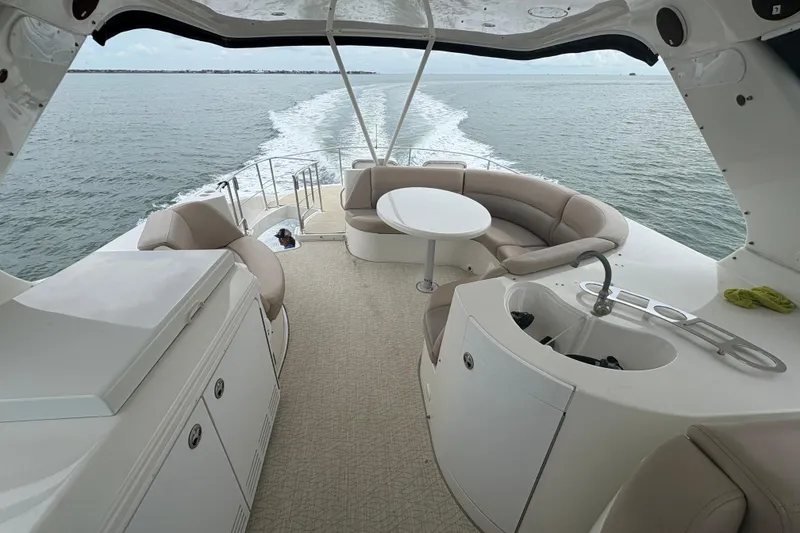 Slide: The Image of Luxurious 2004 Carver 560 Voyager yacht interior with seating and ocean view. - 26
