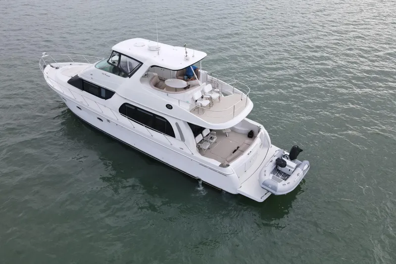 Slide: The Image of 2004 Carver 560 Voyager yacht cruising on calm waters, aerial view. - 3
