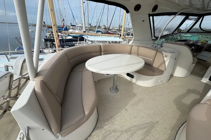 Slide: The Image of Luxurious seating area on a 2004 Carver 560 Voyager yacht with a round table. - 36
