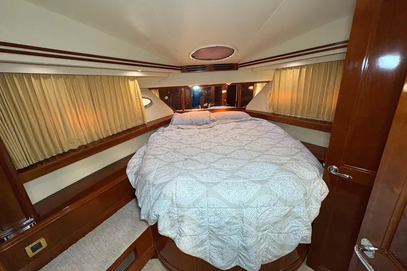 Slide: The Image of Luxurious bedroom interior of 2004 Carver 560 Voyager yacht with elegant bedding and wood accents. - 42