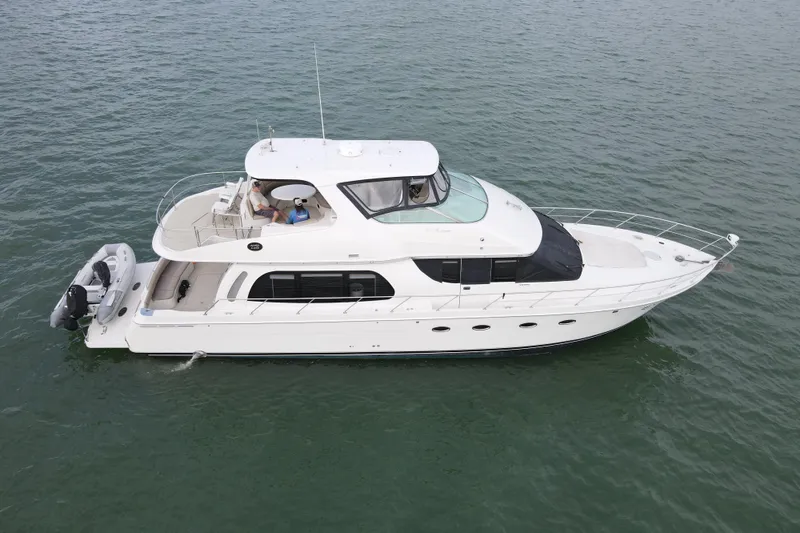 Slide: The Image of 2004 Carver 560 Voyager yacht cruising on open water. - 5