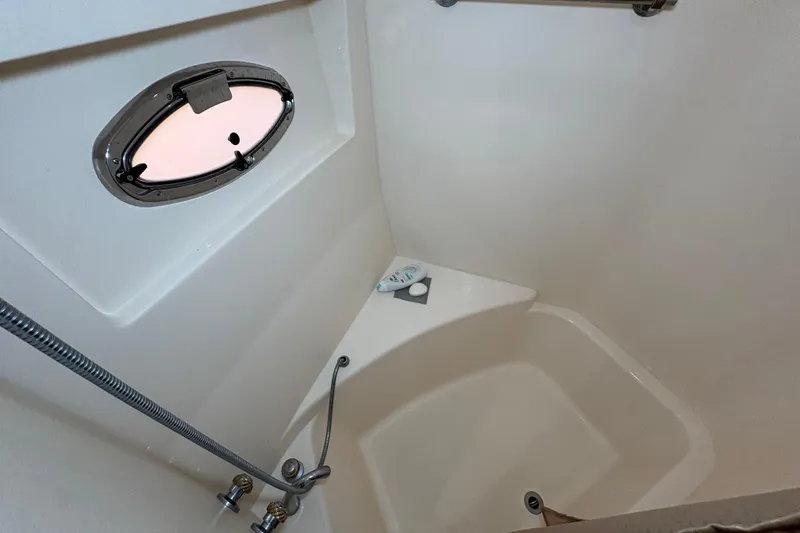 Slide: The Image of Shower area in 2004 Carver 560 Voyager yacht with porthole and fixtures. - 53