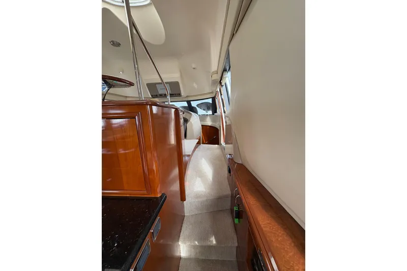 Slide: The Image of Interior view of 2004 Carver 560 Voyager yacht, featuring elegant wood finishes and plush carpeting. - 66