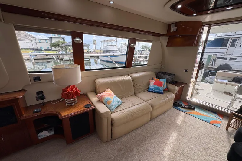 Slide: The Image of Luxurious interior of a 2004 Carver 560 Voyager yacht with beige sofa and colorful pillows. - 67