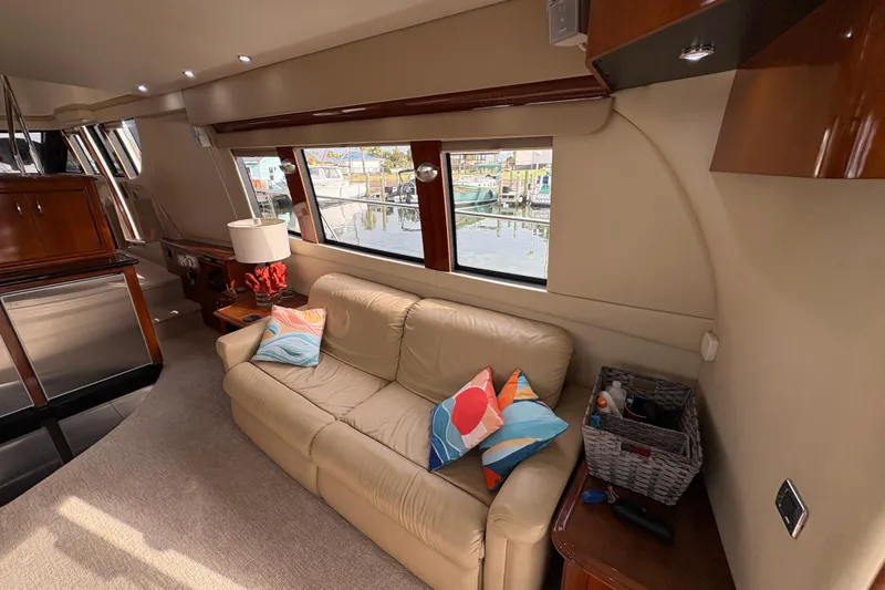 Slide: The Image of Interior of 2004 Carver 560 Voyager yacht with beige sofa and colorful pillows. - 76