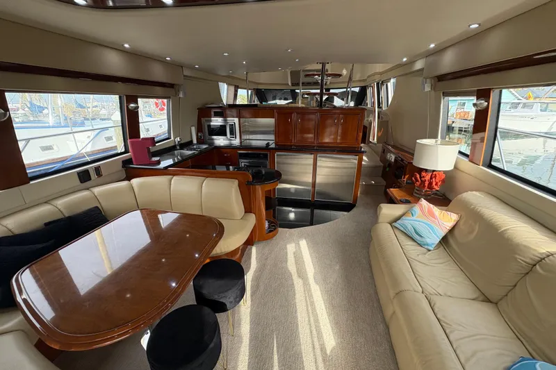 Slide: The Image of Luxurious interior of a 2004 Carver 560 Voyager yacht with elegant seating and modern kitchen. - 77