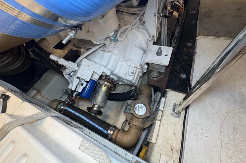 Slide: The Image of Engine compartment of a 2004 Carver 560 Voyager yacht, showcasing mechanical components and piping. - 79