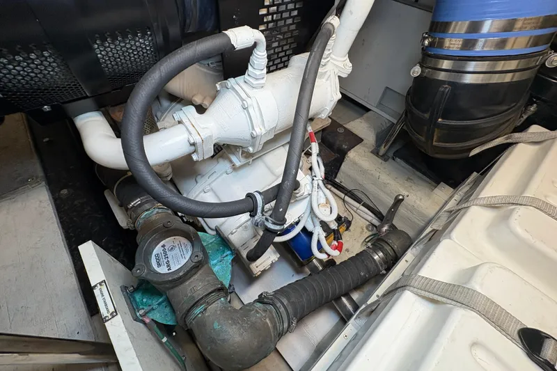 Slide: The Image of Engine compartment of a 2004 Carver 560 Voyager yacht, showcasing mechanical components. - 80