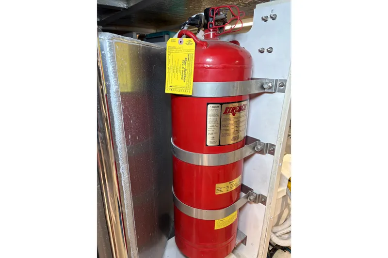 Slide: The Image of Red fire extinguisher mounted on a 2004 Carver 560 Voyager yacht. - 96