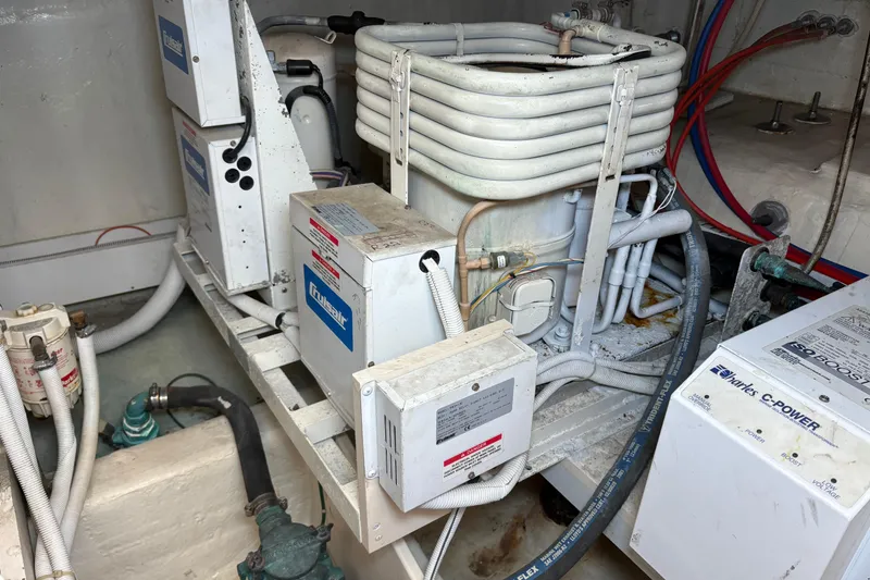 Slide: The Image of Engine room of a 2004 Carver 560 Voyager yacht, featuring mechanical components and wiring. - 97