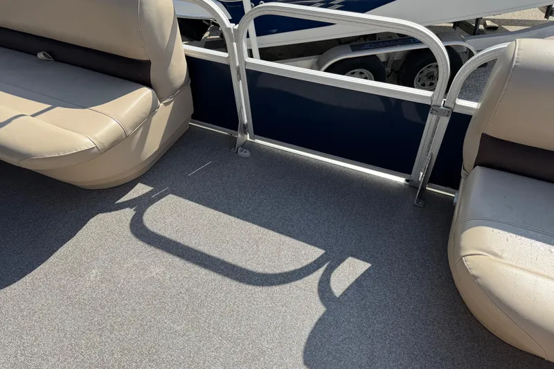 Slide: The Image of 2019 Sun Tracker Party Barge 18 DLX interior with beige seating and gray flooring. - 11