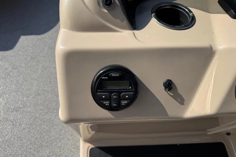 Slide: The Image of Control panel of a 2019 Sun Tracker Party Barge 18 DLX with audio system and cup holder. - 19