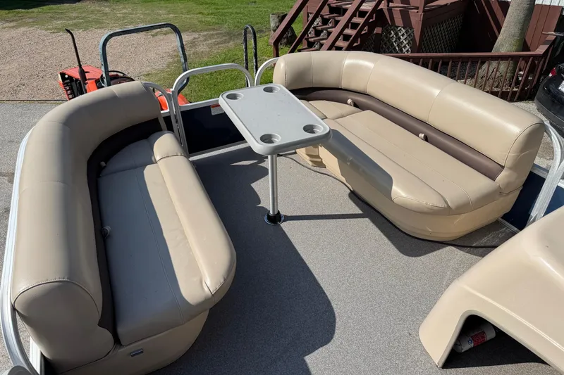 Slide: The Image of 2019 Sun Tracker Party Barge 18 DLX with beige seating and table on deck. - 3