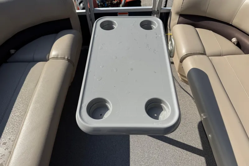 Slide: The Image of 2019 Sun Tracker Party Barge 18 DLX interior with table and cup holders. - 5
