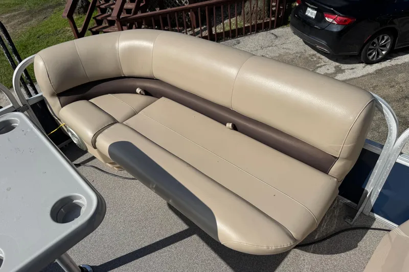 Slide: The Image of 2019 Sun Tracker Party Barge 18 DLX with beige seating and cupholder table. - 6