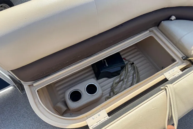 Slide: The Image of Open storage compartment in 2019 Sun Tracker Party Barge 18 DLX with cup holders and rope. - 9