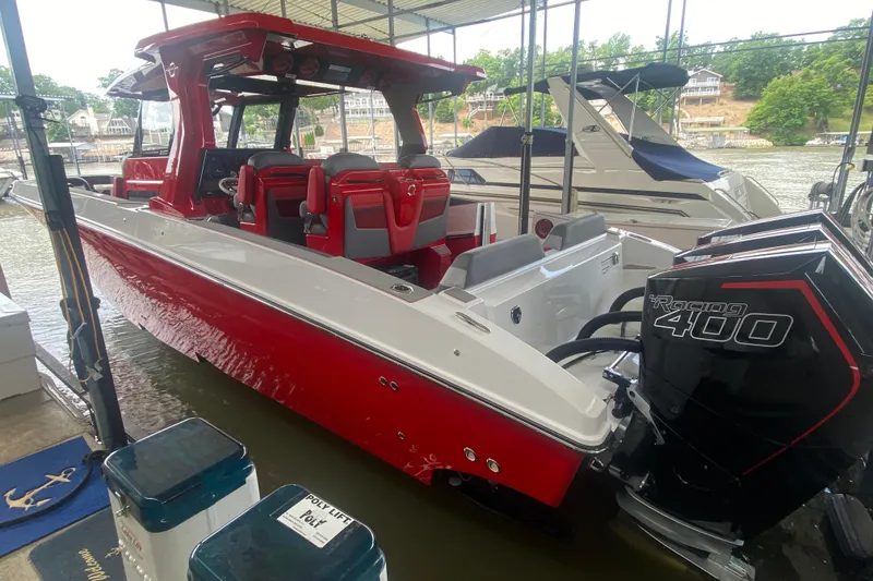 Slide: The Image of 2025 Fountain 38 SCX boat with red and white design, docked with powerful Racing 400 engines. - 10