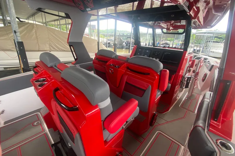 Slide: The Image of Interior of 2025 Fountain 38 SCX boat with red and gray seating and modern dashboard. - 14