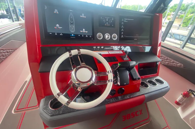 Slide: The Image of 2025 Fountain 38 SCX boat dashboard with modern controls and dual display screens. - 17