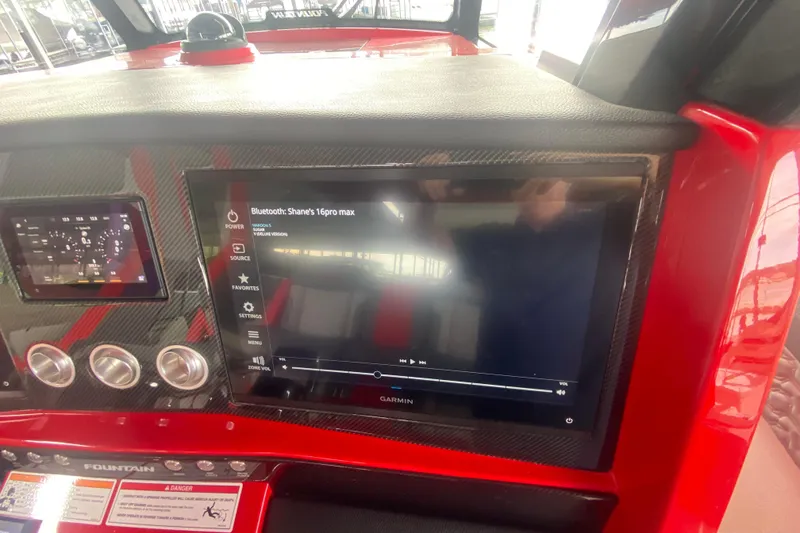 Slide: The Image of 2025 Fountain 38 SCX dashboard with touchscreen display and control panel. - 18