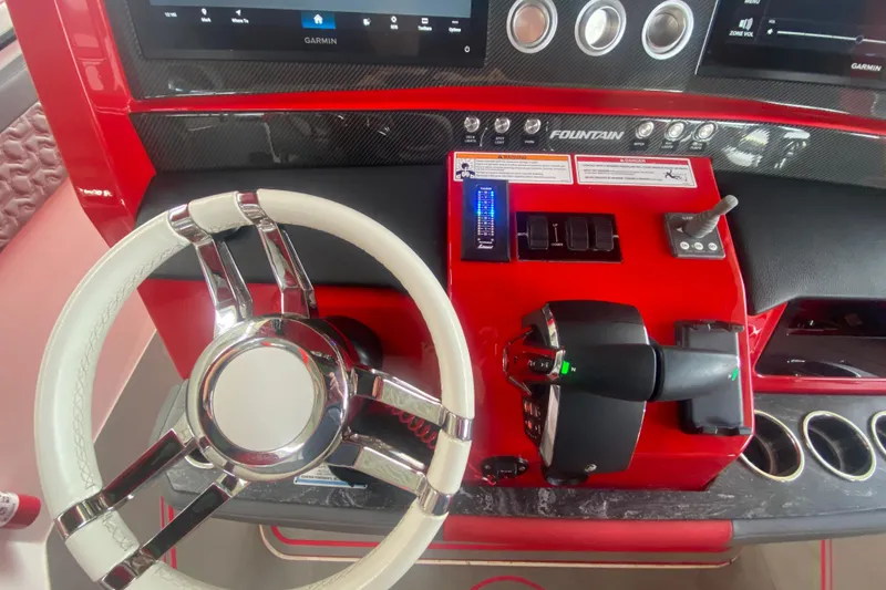 Slide: The Image of Red and black dashboard of 2025 Fountain 38 SCX boat with steering wheel and controls. - 20