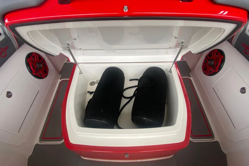 Slide: The Image of Open storage compartment in 2025 Fountain 38 SCX boat with speakers and fenders. - 25