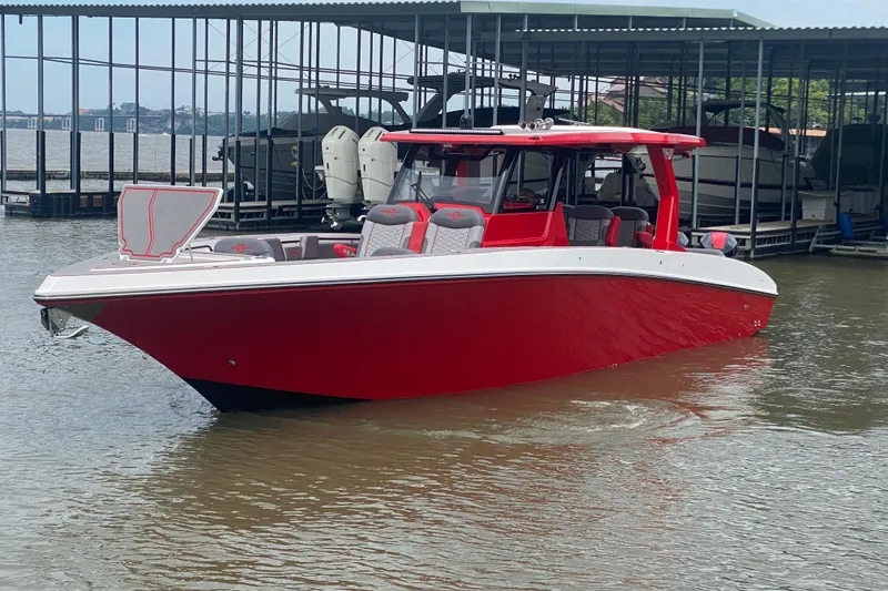 Slide: The Image of Red 2025 Fountain 38 SCX boat docked on a lake, showcasing sleek design and modern features. - 3