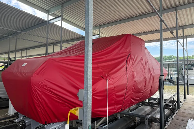 Slide: The Image of 2025 Fountain 38 SCX boat covered in red tarp at marina dock. - 35