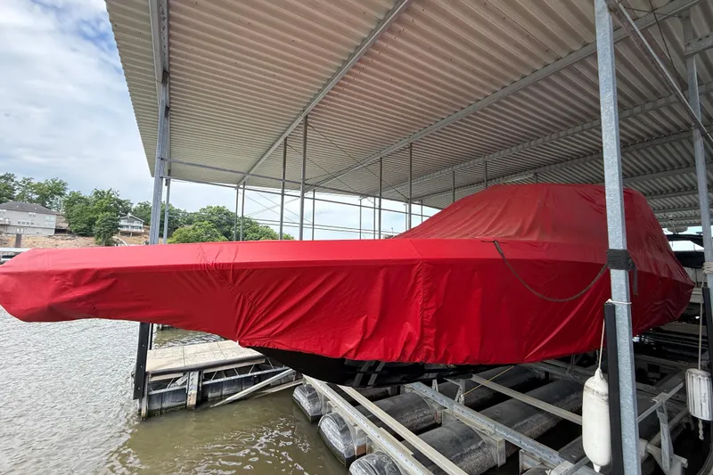 Slide: The Image of 2025 Fountain 38 SCX boat covered in red tarp at a dock. - 37
