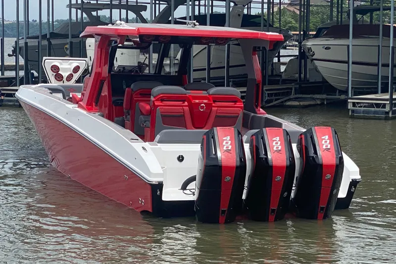 Slide: The Image of 2025 Fountain 38 SCX boat with four powerful outboard engines, docked in a marina. - 6