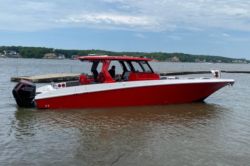 Slide: The Image of Red 2025 Fountain 38 SCX boat on a lake, featuring sleek design and powerful engine. - 7
