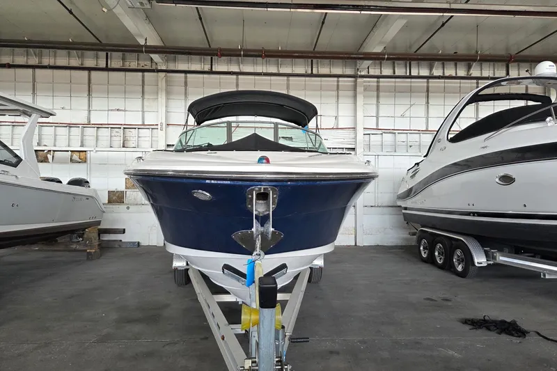Slide: The Image of 2005 Sea Ray 270 SLX boat in storage, front view, indoors. - 1