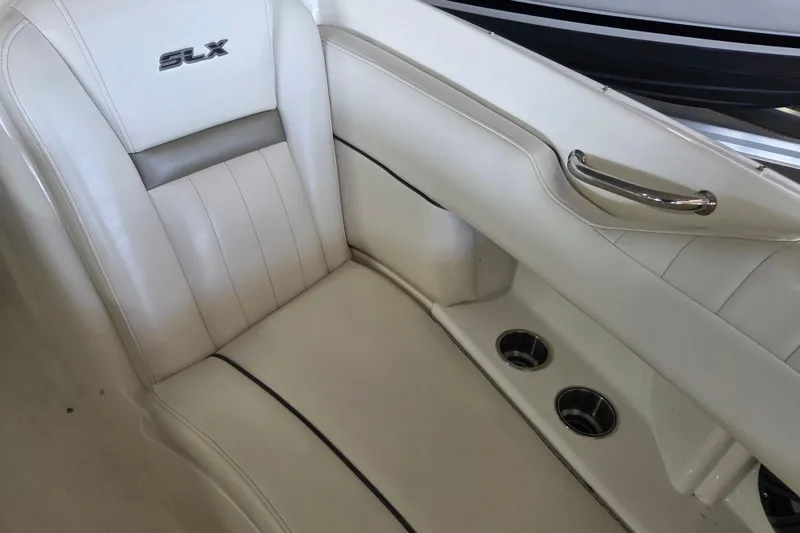 Slide: The Image of 2005 Sea Ray 270 SLX boat interior with white leather seating and cup holders. - 10