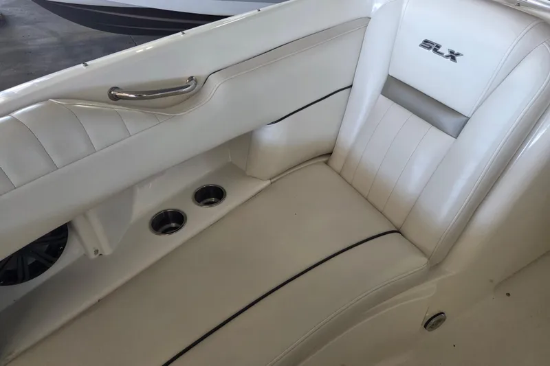 Slide: The Image of 2005 Sea Ray 270 SLX boat interior with white leather seating and cup holders. - 11