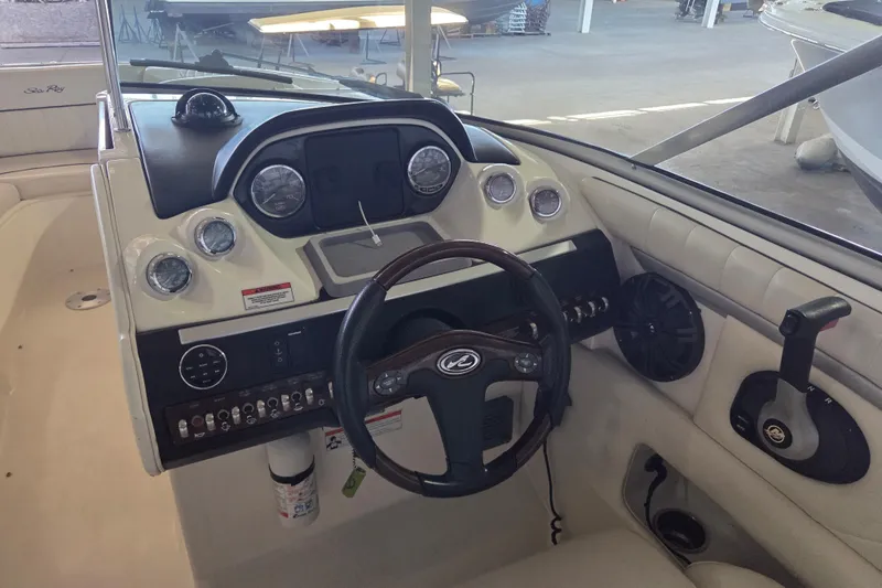 Slide: The Image of 2005 Sea Ray 270 SLX boat dashboard with steering wheel and control panel. - 12