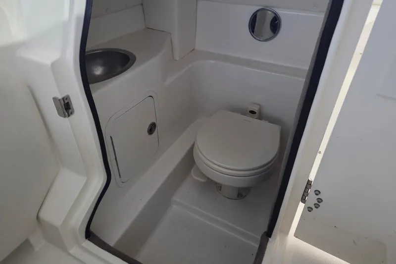 Slide: The Image of 2005 Sea Ray 270 SLX boat bathroom with toilet and sink. - 13