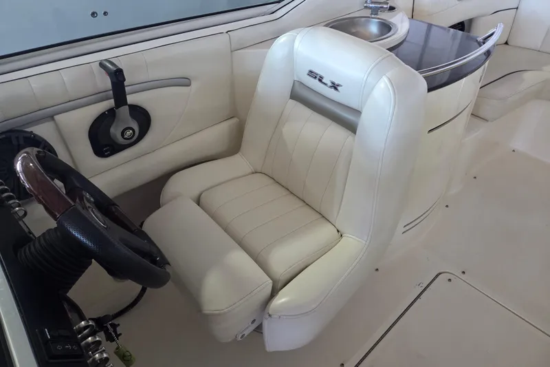 Slide: The Image of Luxurious interior of a 2005 Sea Ray 270 SLX boat with white leather seating. - 14