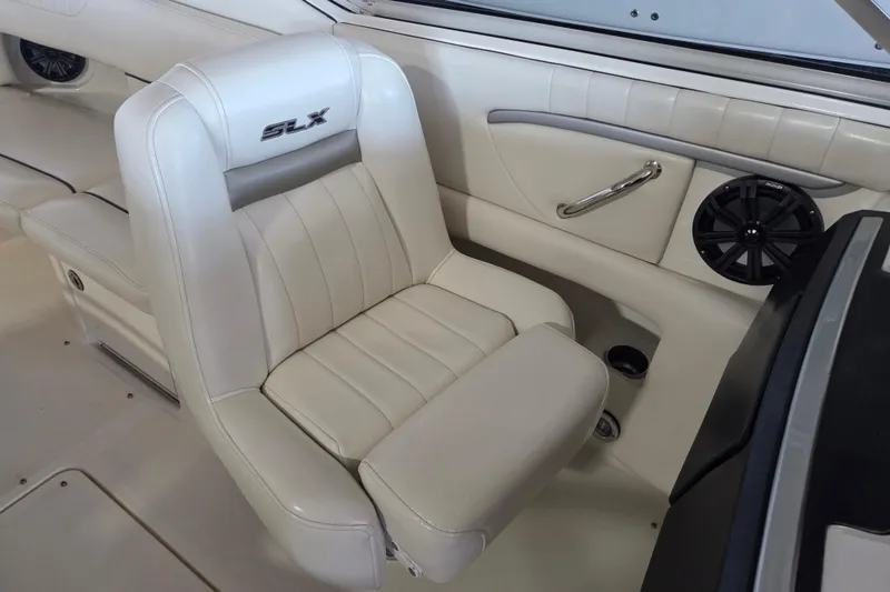 Slide: The Image of 2005 Sea Ray 270 SLX boat interior with white leather seating and speaker. - 15