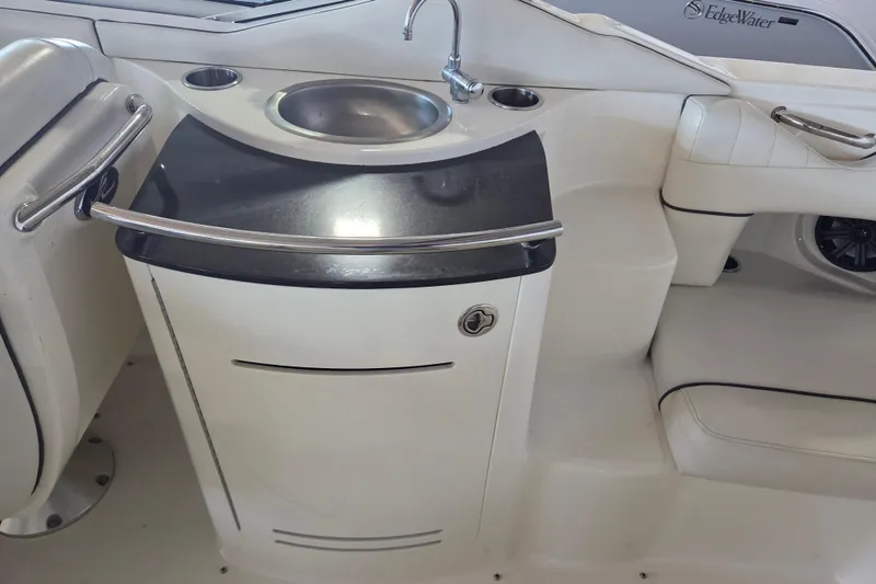 Slide: The Image of 2005 Sea Ray 270 SLX boat interior with sink and seating area. - 16