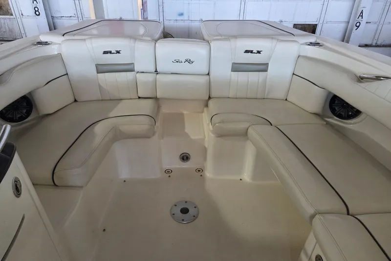 Slide: The Image of Interior seating of a 2005 Sea Ray 270 SLX boat, featuring white leather upholstery. - 17