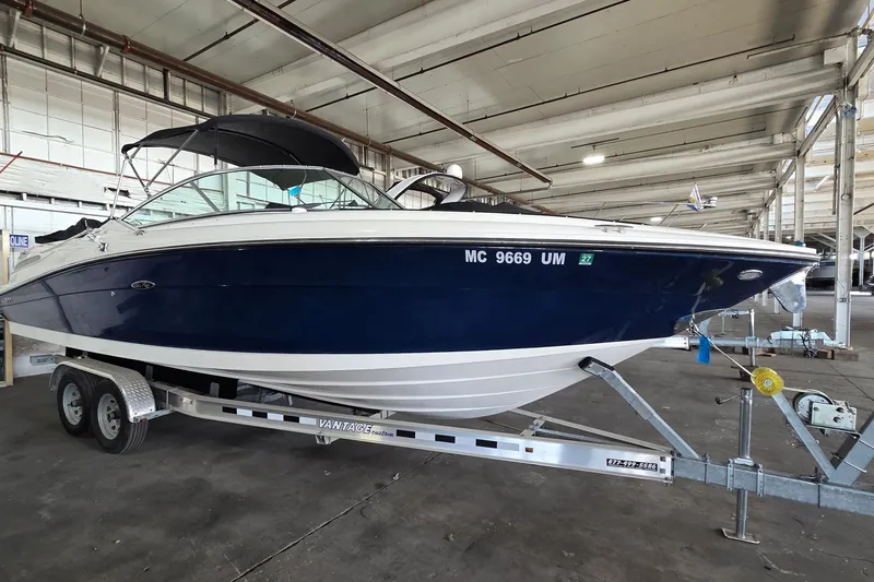 Slide: The Image of 2005 Sea Ray 270 SLX boat on trailer in indoor storage facility. - 2