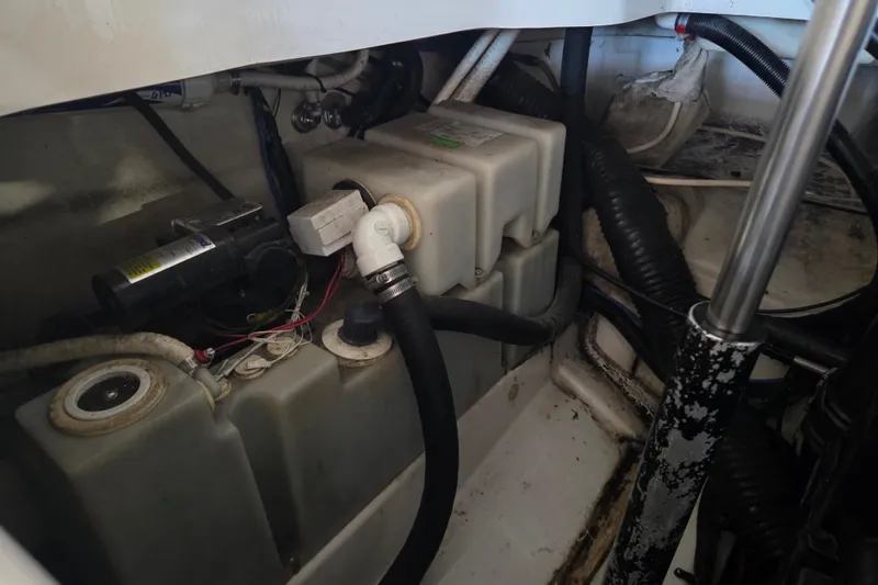 Slide: The Image of Engine compartment of a 2005 Sea Ray 270 SLX boat, showing tanks and hoses. - 24