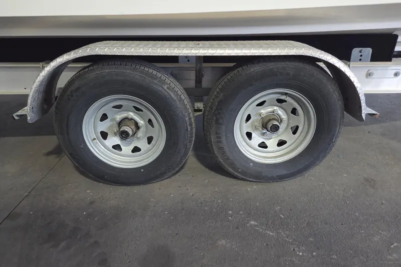 Slide: The Image of Trailer wheels for 2005 Sea Ray 270 SLX boat, featuring dual tires and metal fender. - 28