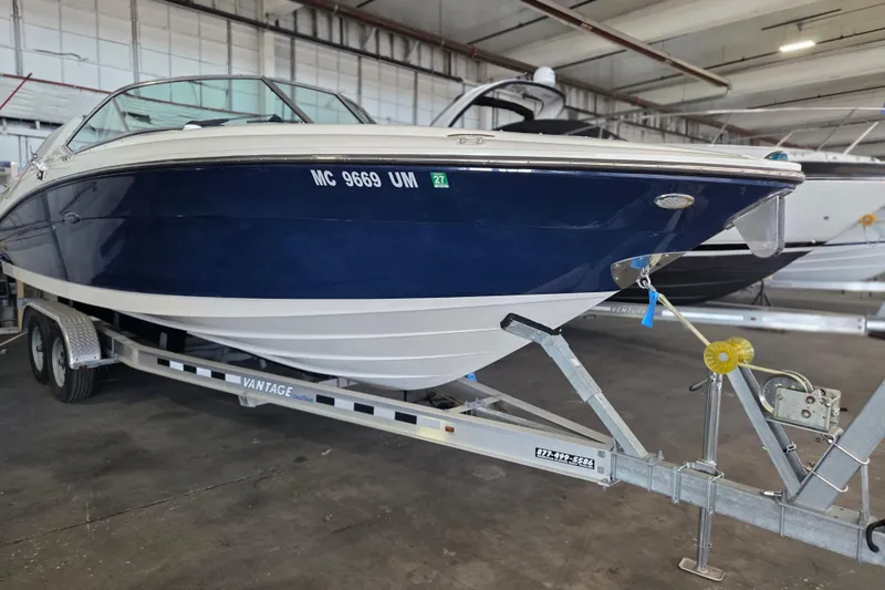 Slide: The Image of 2005 Sea Ray 270 SLX boat on trailer in indoor storage facility. - 29