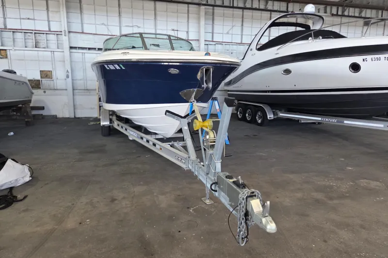 Slide: The Image of 2005 Sea Ray 270 SLX boat on trailer in indoor storage facility. - 30
