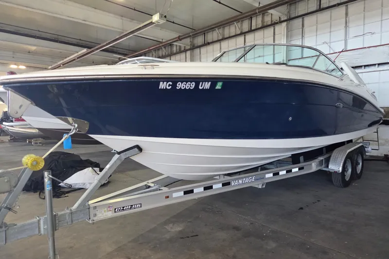 Slide: The Image of 2005 Sea Ray 270 SLX boat on trailer in indoor storage facility. - 31