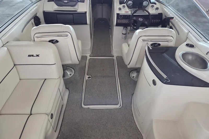 Slide: The Image of 2005 Sea Ray 270 SLX boat interior with seating, steering wheel, and sink. - 5
